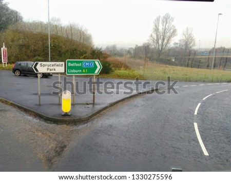 a Road sign indicating the way to Belfast City