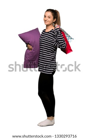 Full body Pretty woman in pajamas holding a lot of shopping bags on isolated background