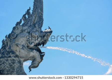 Beautiful ancient Naga statue, ancient art of Songkhla province in southern Thailand
That is spraying water out of the mouth
