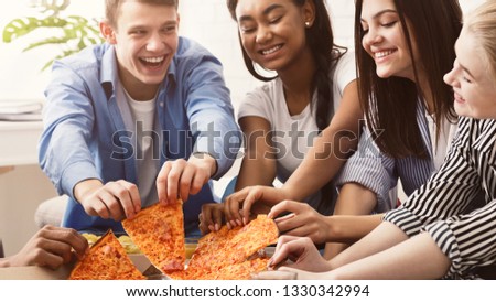 Happy friends eating pizza, spending time together at home