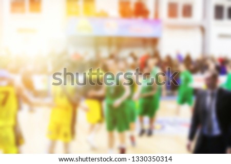 Blurred background of basketball players in court Yellow and green players uniform, good concept idea.