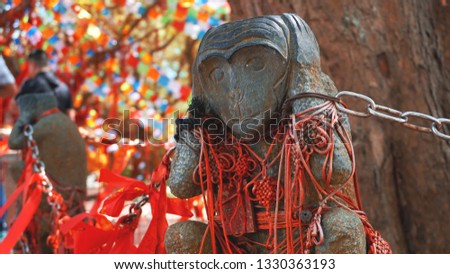 Hear no evil monkey statue in Hainan monkey forest, China