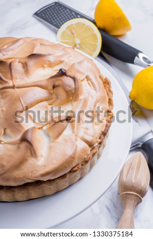 Lemon meringue pie with lemon and slice of pie