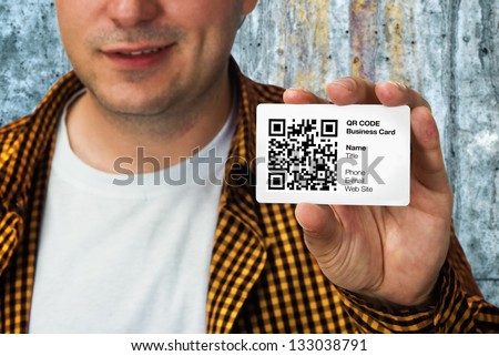 Construction worker holding a QR code business card, business introduction concept.
