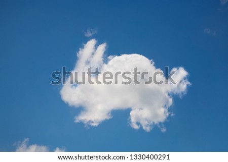 Rabbit shaped cloud in a blue sky Royalty-Free Stock Photo #1330400291