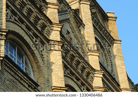 yellow brick university building with windows
