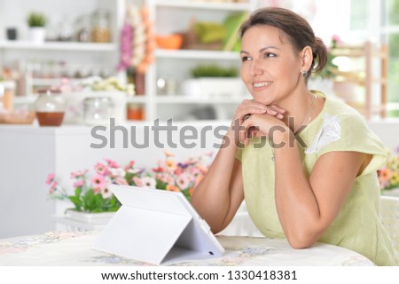 Portrait of cute young woman using digital tablet