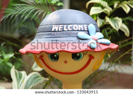 Welcome sign on a doll head