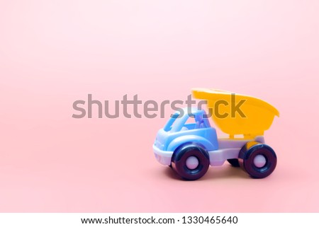 Truck toy model car on pink background, space for text