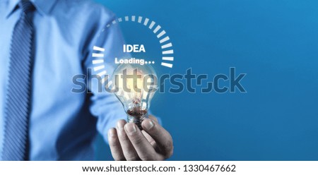 Man holding light bulb. Idea loading
