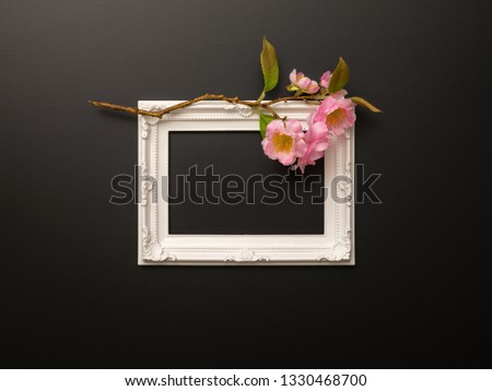 An image of a white frame on black background with cherry blossoms