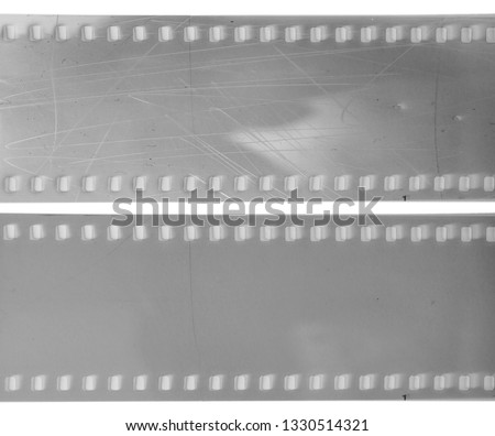 real macro photo of long 35mm film strip with and without scratched surface or texture on white background