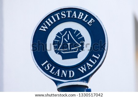 A signpost for Whitstable Island Wall in the seaside town of Whitstable in Kent, England. 
