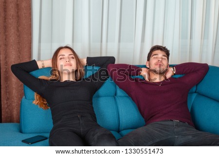 Satisfied couple sleeping sitting on a sofa, relaxing closed eyes putting hands behind head feels good after healthy rest with husband horizontal photo banner for website header design