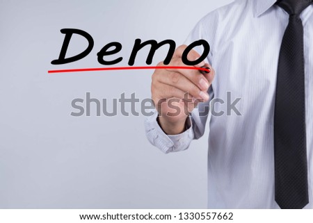Businessman hand writing Demo with red marker on transparent wipe board, business concept