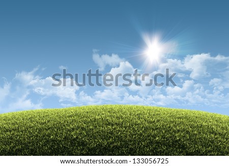Sunny natural summer background with grassy hill and clear blue sky - great copy-space for posters, cards or banners