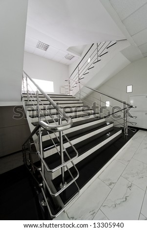 Marble staircase with a steel handrail in a modern building