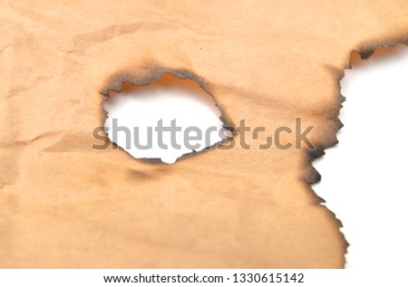 Grunge paper with charred edges on white background