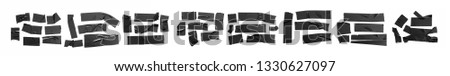 Set of black tapes on white background. Torn horizontal and different size black sticky tape, adhesive pieces. Royalty-Free Stock Photo #1330627097