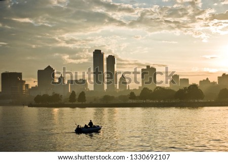 Milwaukee skyline sunset with fishing boat.