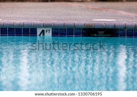 4 four foot or feet sign showing swimming pool depth