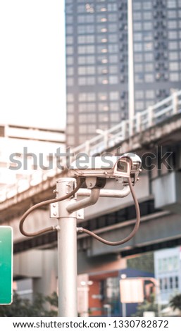 Security camera equipment and traffic concept - Security camera equipment on pole in evening traffic light with flare light effect and copy space