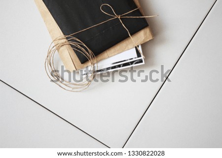 Top view of composition with envelopes with photos. Minimal Design Mockup on gray white background. Creative Workplace Layout.