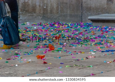 Legs walking on confetti in a celebration