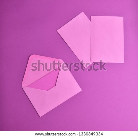 Pink envelopes on a purple background, top view