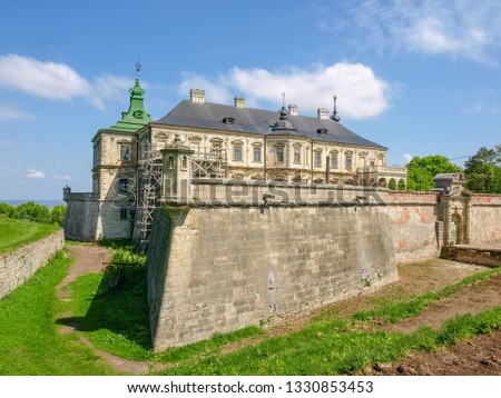 South part of the renaissance and baroque Pidhirtsi castle-fortress built in the mid 17th century in spring day. Lviv Oblast, Ukraine
