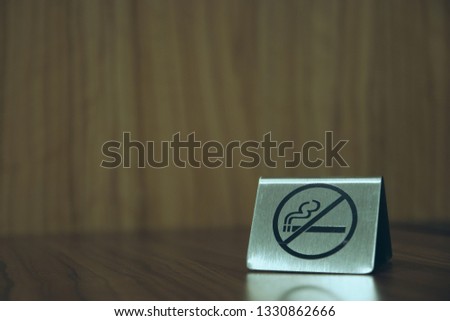 Warning sign. no smoking on the table in the room. Iron plate on the table does not smoke close-up. horizontal view. copy space
