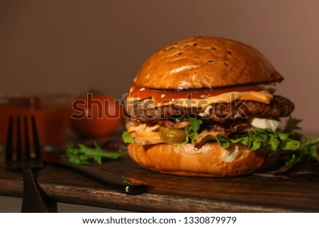 Tasty burger on table