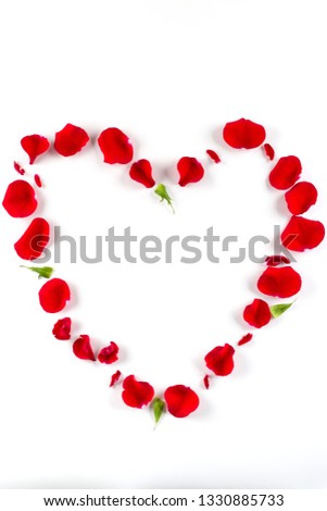 Heart shape made of red rose petals, on white background. Top view, copy space for text