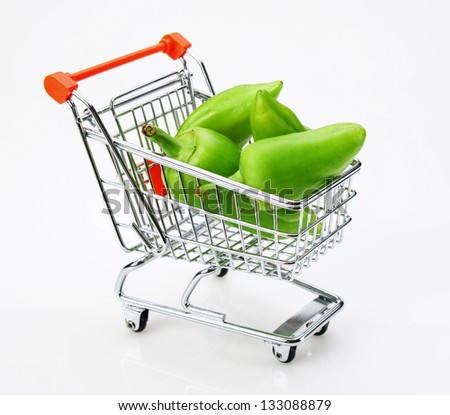 Green sweet pepper paprika  in shopping trolley on white background