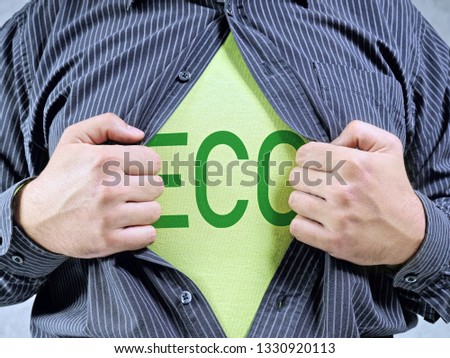 A man wearing shirt showing green ECO word imprinted on T-shirt underneath