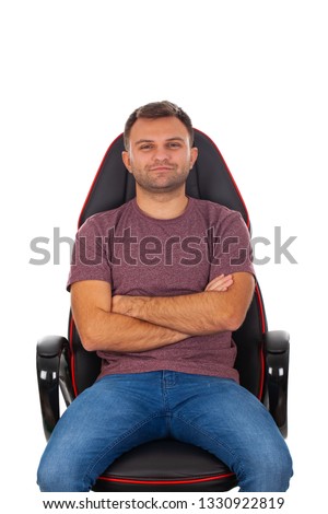 Picture of a happy young entrepreneur sitting on a comfortable office chair, smiling to the camera on isolated background