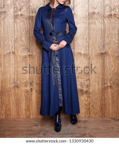 Women's coat, skirt and photomodel posing. Wooden floor. Fashion and design, luxury. Dark colored and leather dress. Islamic fashion - Image