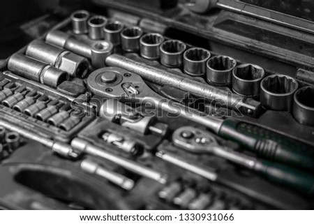 Flat Lay metal tools: wrenches, ratchet, a set of interchangeable heads of different sizes and other tools are in the tool box, a top view. Close-up Carpenter's Tool Kit