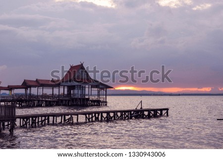 pier at sunset in the beach