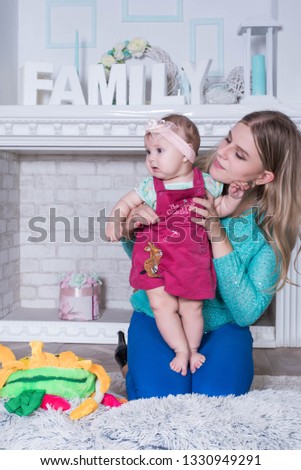 Happy loving family. mother and child girl playing, kissing and hugging at home