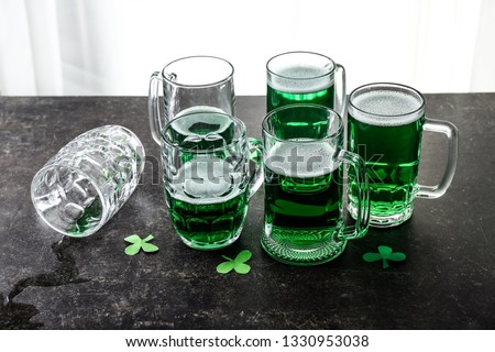 Mugs of green beer on table. St. Patrick's Day celebration