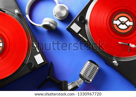 Headphones with modern DJ mixer and microphone color background Royalty-Free Stock Photo #1330967720