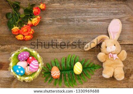 Easter concept. Easter bunny decorative with eggs and flower in pastel colors on wooden background. top view, copy space.Easter Flat lay. Spring Easter Mockup
