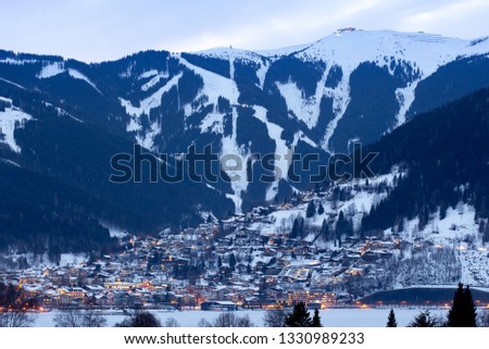Winter panorama of Zell Am See city with ski slopes and mountains covered in snow. Famous ski resort in Austria, Europe.