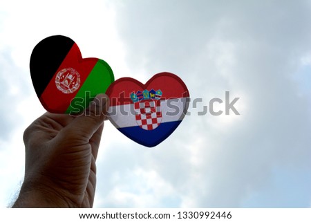 Hand holds a heart Shape Afghanistan and Croatia flag, love between two countries