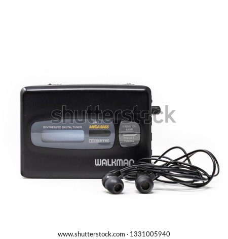 Vintage audio player. Old fashioned portable cassette player, cult object, icon and symbol of the 80s and 90s. Headphones isolated on white background. Royalty-Free Stock Photo #1331005940