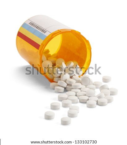 Prescription pill bottle spilling pills on to surface isolated on a white background. Royalty-Free Stock Photo #133102730