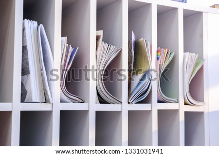 Many magazines on shelves in modern library
