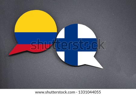 Colombia and Finland flags with two speech bubbles on dark gray background