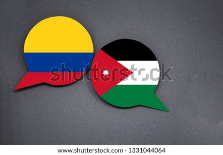 Colombia and Jordan flags with two speech bubbles on dark gray background